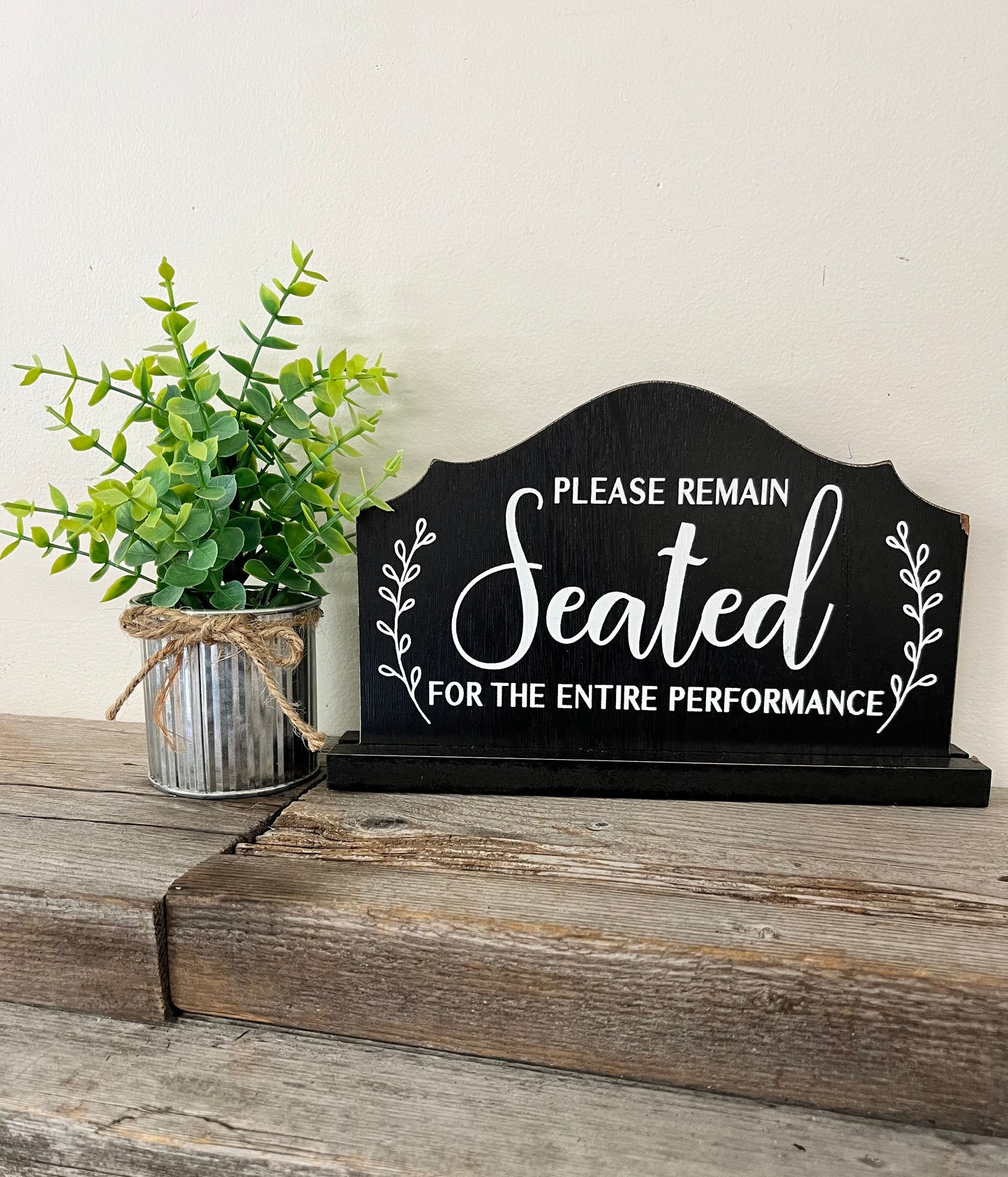 “Please Remain Seated” Sign