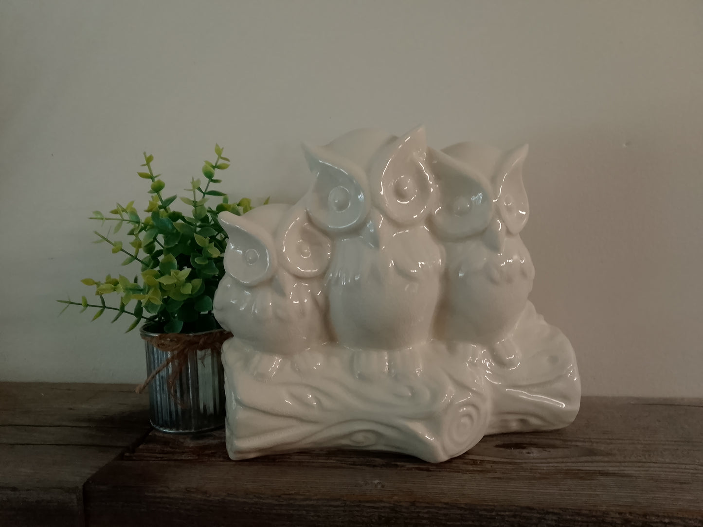 Three cream ceramic owls